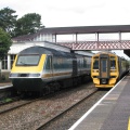 An HST in Kemble Down Platform passes a 158 in the Up Platform.