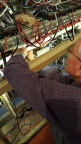 David, with cutters to the fore, trims back cable ties from tidied cable runs & works on the labelling system.