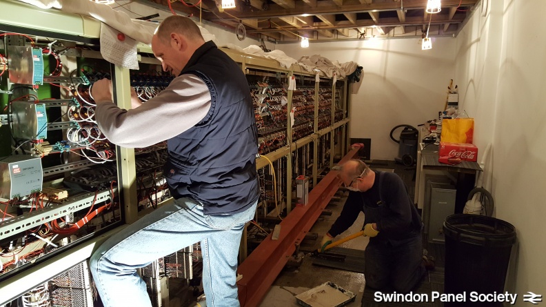 With cleaning done, Peter seals the remaining concrete floor space that was under the panel, while Paul reattaches 8-core cables to repaired circuit boards...watch out for that wet floor behind you Paul! 