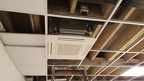With the air-conditioning units in, surrounding ceiling tiles start to be installed, having been cut to size accordingly.