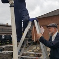 David Brown and Richard Beacham tackle the installation of conduit through the lamp post, which will illuminate the way into the new centre. 