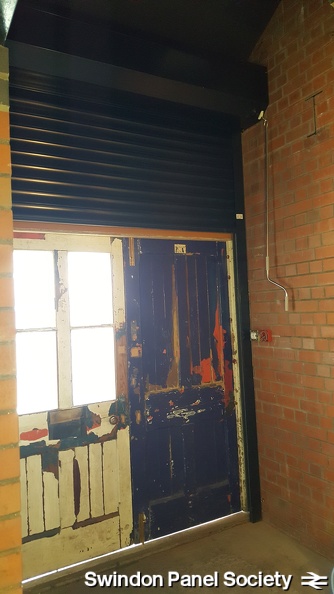 The new roller shutter is installed behind the front doors, and is tested in situ.