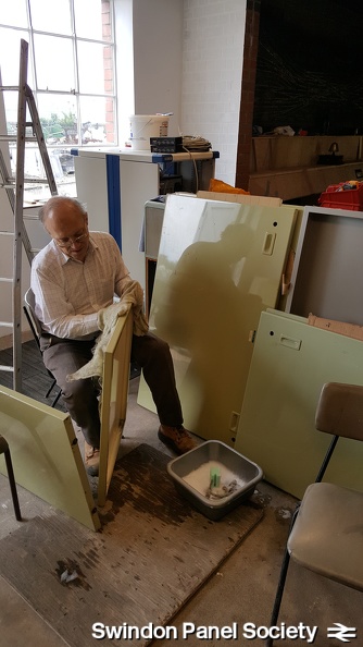 As more space becomes available at the front of the panel, Peter Woodbridge continues with the unenviable task of cleaning the panel's front and rear metal covers.